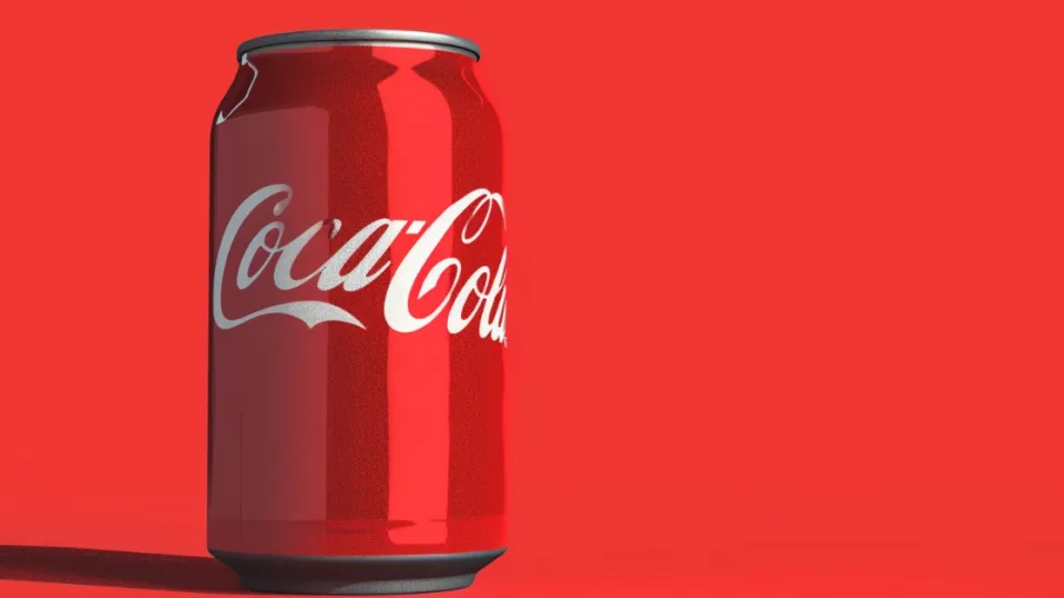 Red Coca-Cola can with white script logo on a red background