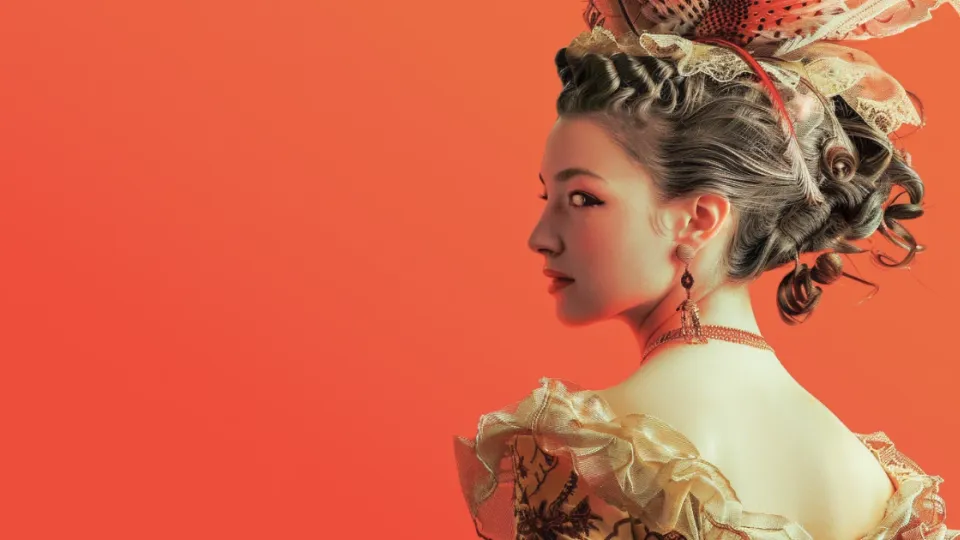Woman in tall powdered rococo hairstyle with feathers and ruffled gown