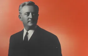 H.B. Reese portrait, halftone black-and-white photo on red background