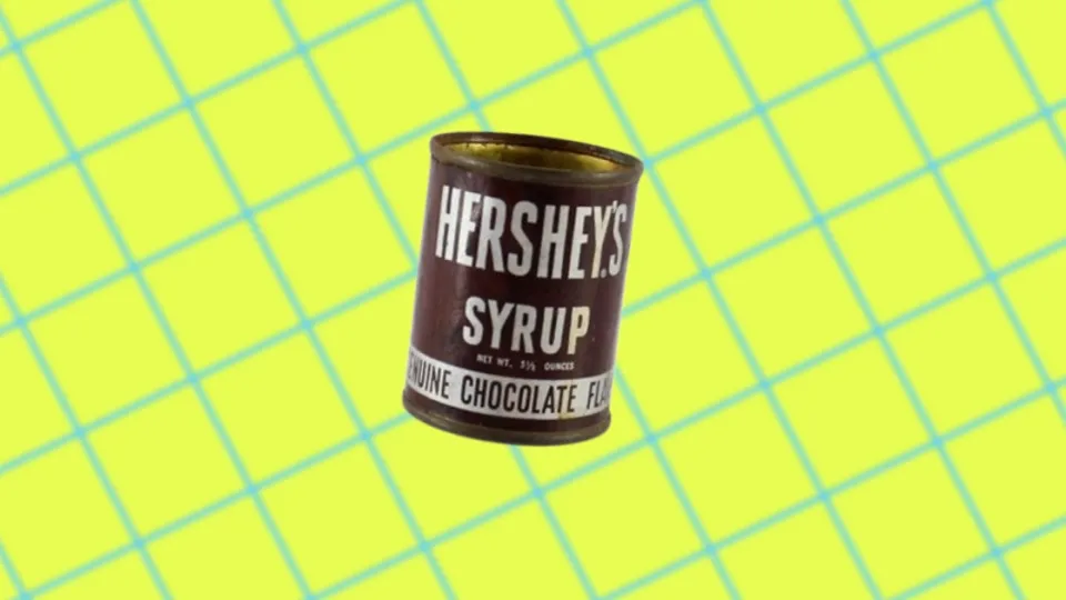 Vintage Hershey’s Syrup tin can with white lettering on brown label