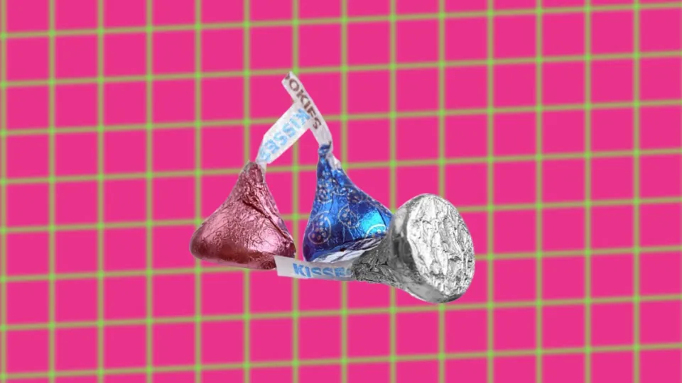 Three Hershey’s Kisses in pink, blue and silver foil wrappers