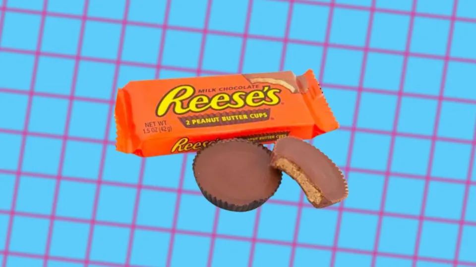 Reese's Peanut Butter Cups orange wrapper beside two chocolate cups