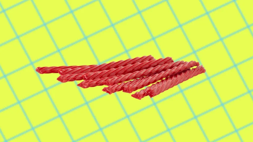 Red strawberry Twizzlers twists on a yellow grid background