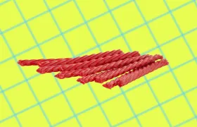Red strawberry Twizzlers twists on a yellow grid background
