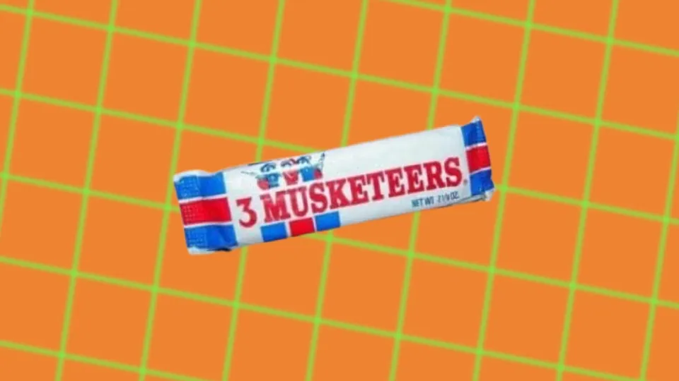 Vintage 3 Musketeers candy bar wrapper on orange grid background