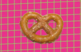 Hard salted pretzel twist on pink and green grid background