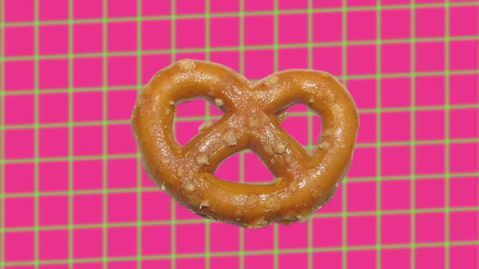 Hard salted pretzel twist on pink and green grid background