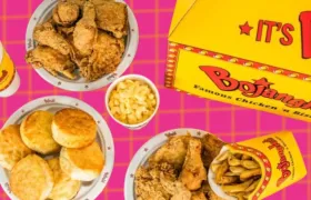 Bojangles fried chicken, biscuits and mac and cheese on pink background