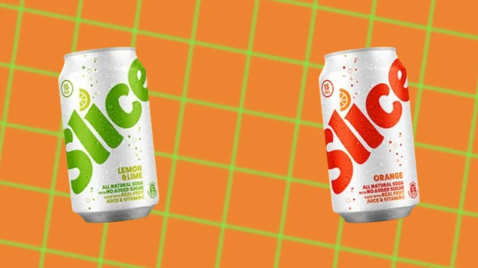 White Slice lemon-lime and orange soda cans on an orange grid background