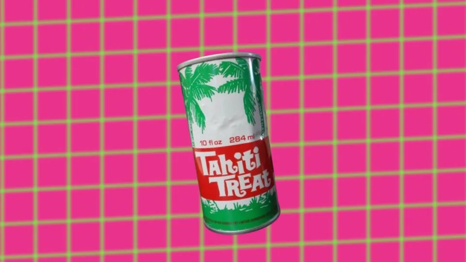 Vintage Tahiti Treat soda can with palm trees on pink background