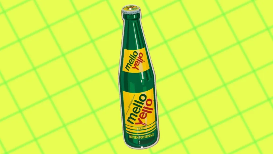 Vintage green glass Mello Yello bottle on yellow grid background
