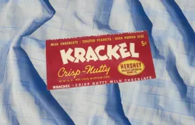Vintage five-cent Krackel Crisp-Nutty chocolate bar wrapper on blue plaid fabric