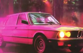 Vintage BMW 5 Series sedan with glowing headlights in neon pink