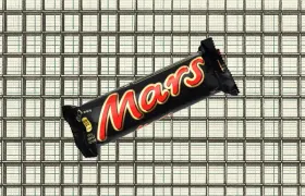 Mars chocolate bar in its black and red wrapper on a tiled background