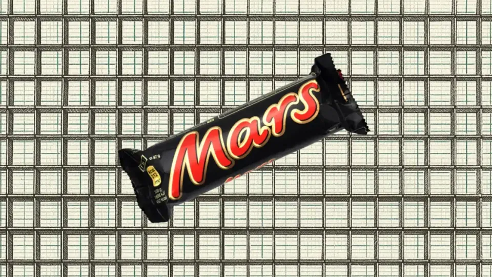 Mars chocolate bar in its black and red wrapper on a tiled background