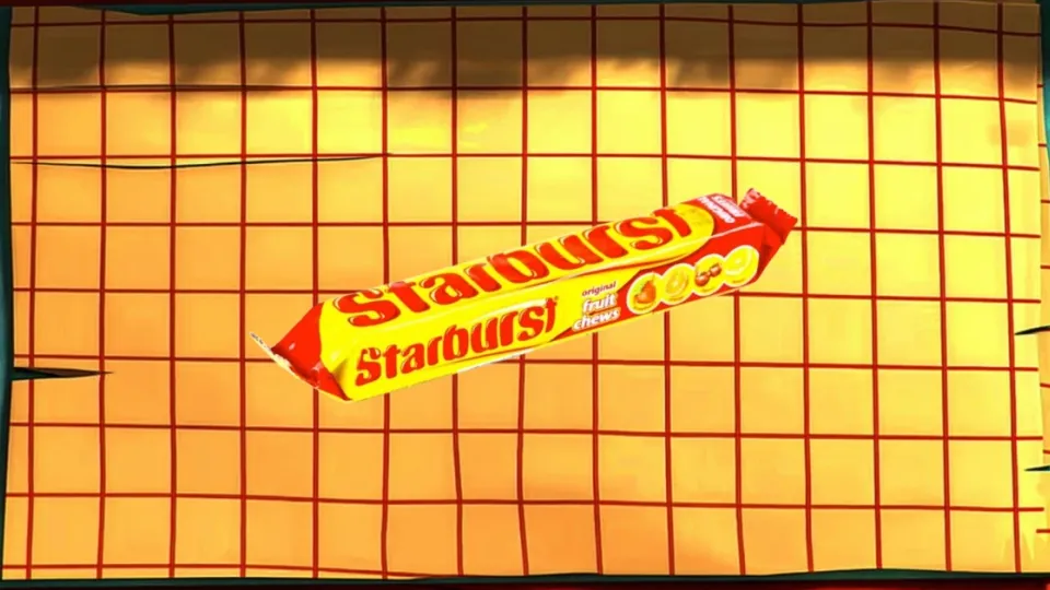 Starburst original fruit chews pack on an orange tiled surface