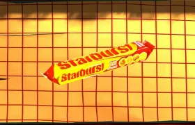 Starburst original fruit chews pack on an orange tiled surface