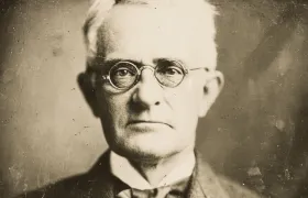 George Eastman portrait, elderly man in round wire-rim glasses, sepia photograph