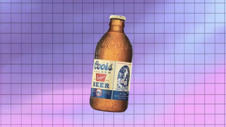 Coors Golden Banquet Beer stubby bottle against purple grid background