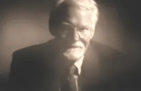 Elderly bearded man in a suit, soft focus sepia portrait