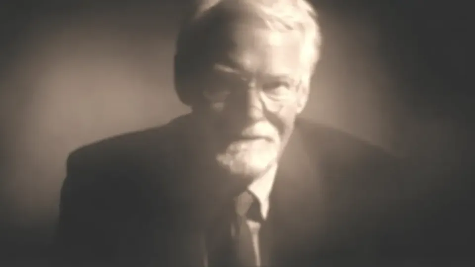 Elderly bearded man in a suit, soft focus sepia portrait