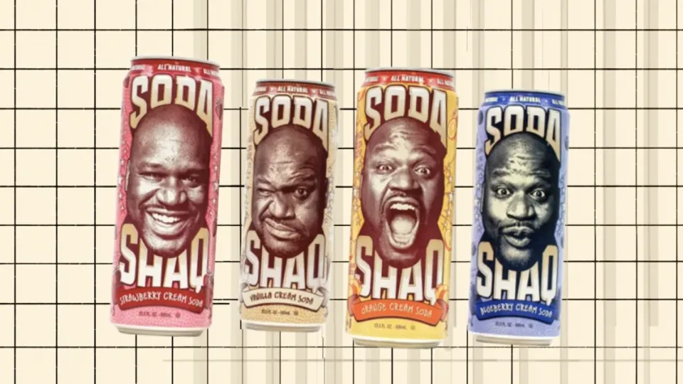 Four Shaq Soda cans: strawberry, vanilla, orange and blueberry cream