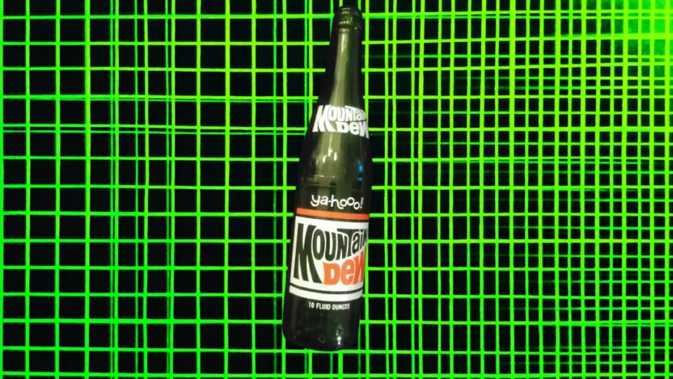 Vintage Mountain Dew glass bottle with "ya-hooo!" label