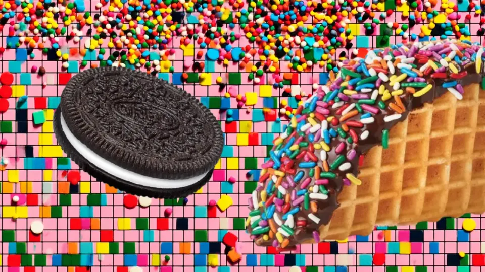 Oreo cookie beside chocolate-dipped waffle taco shell covered in rainbow sprinkles