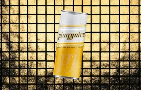 Gold and white Pimp Juice energy drink can on gold tile