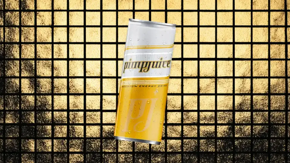 Gold and white Pimp Juice energy drink can on gold tile