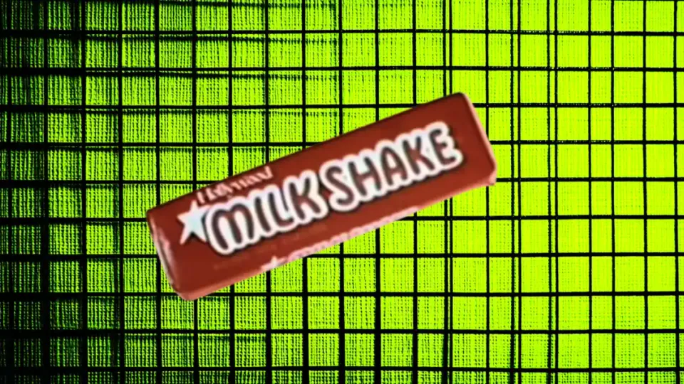 Milk Shake candy bar in red wrapper on neon green grid