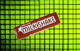 Milk Shake candy bar in red wrapper on neon green grid