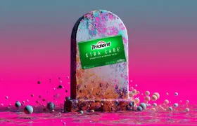 Trident Xtra Care gum pack on a tombstone in a surreal pink scene