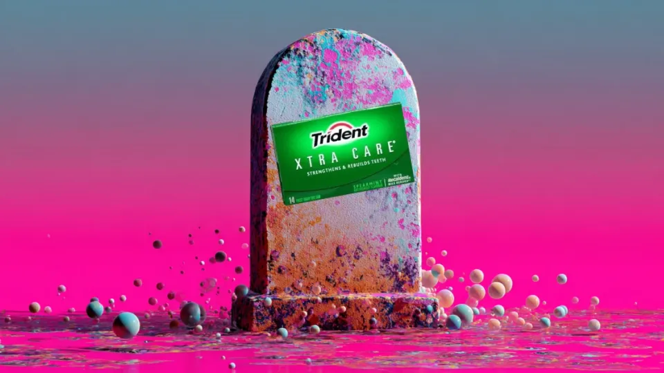 Trident Xtra Care gum pack on a tombstone in a surreal pink scene