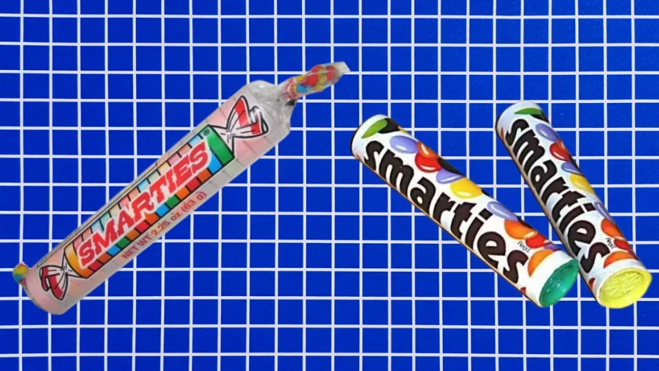 American Smarties candy roll beside two Nestle Smarties chocolate candy tubes