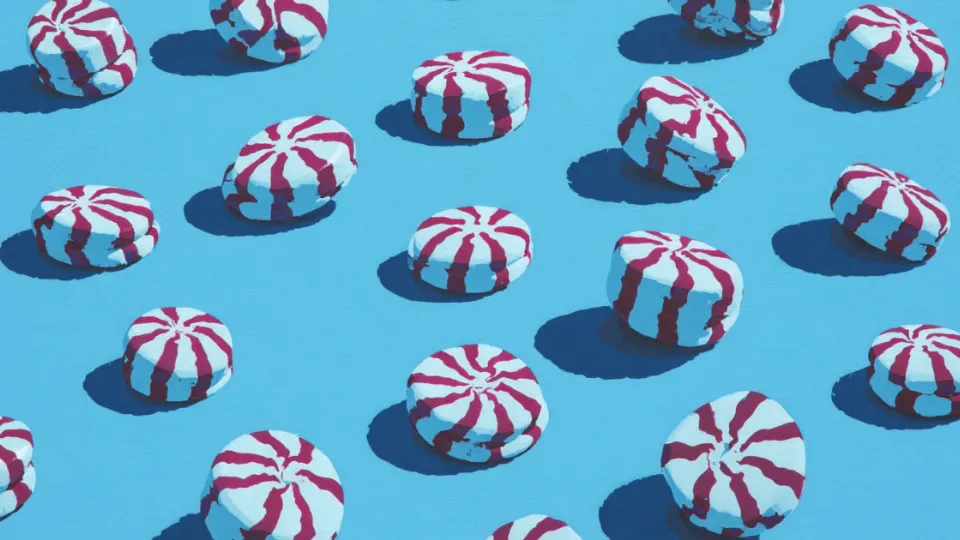 Red and white striped starlight peppermint candies on a blue background