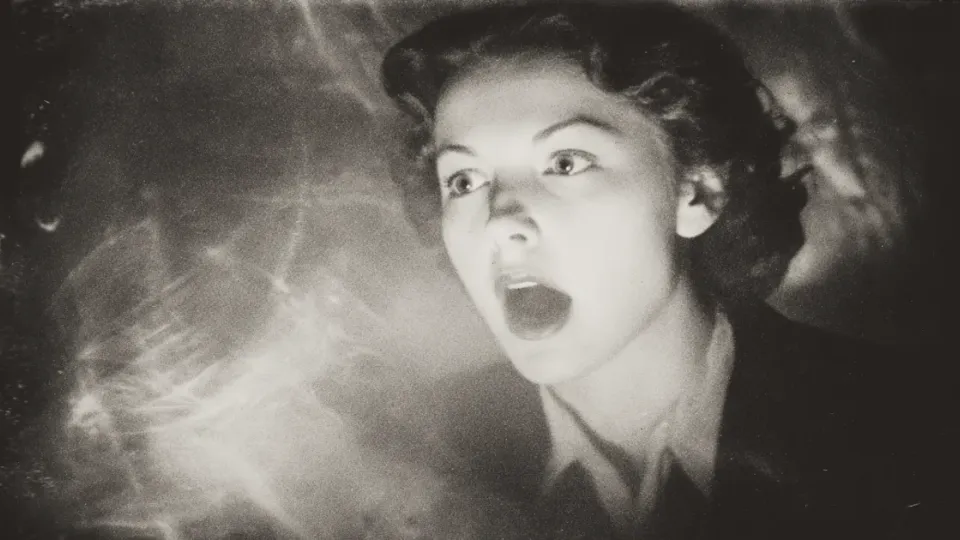 Terrified woman screaming amid ghostly streaks of light, staged in vintage photograph style